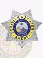 Close-up of a silver 7-point star badge with gold accent panels for Florida Fugitive Recovery Agents, detailed embossed design and secured with a safety pin fastener.