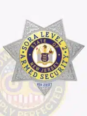 Silver seven-point star badge with gold accents designed for SORA Level II armed security officers, displaying "SORA Level 2 Armed Security" text and the New Jersey state emblem, attached with a safety pin.
