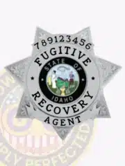 Custom silver metal badge for Fugitive Recovery Agent from Idaho, featuring an 7 point star design with intricate floral patterns on each point, centered with the state seal of Idaho, and a safety pin attachment on the back.
