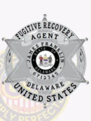 Silver 6-point star badge designed for Fugitive Recovery Agents, displaying the Delaware state seal at the center. The badge is personalized with James Franklin and agent ID 6712345, surrounded by a circular banner reading 'Fugitive Recovery Agent Delaware United States,' with a safety pin for fastening.