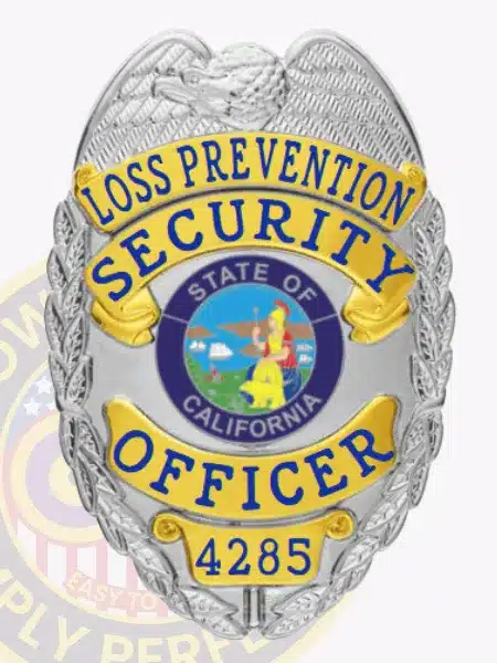 Silver metal badge with gold accents for California Loss Prevention Security Officers, including a raised eagle emblem on top, blue text on gold banners, state seal center, and safety pin attachment.