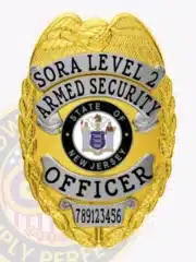 Close-up image of a custom gold metal badge for SORA Level 2 armed security officers, showing silver banners with black embossed text, an eagle motif at the top, the State of New Jersey seal in the center, and a safety pin attachment on the reverse.