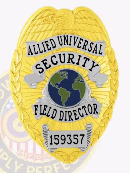 Gold metal badge with custom gold eagle top and silver panels for Allied Universal Field Director, showing badge number 159357 and a globe emblem, attached with a safety pin.