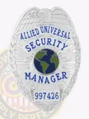 Custom silver metal badge for Allied Universal security managers, with an eagle embossed at the top, a globe emblem in blue and green center, manager rank clearly printed in blue letters, and a safety pin attachment on the back for easy and secure fastening.