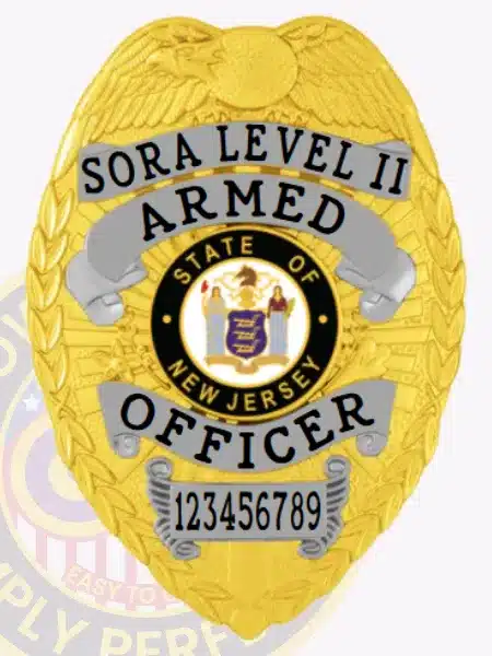 Close-up image of a custom gold metal badge for SORA Level II armed officers, displaying silver banners with black embossed text, an eagle motif at the top, the State of New Jersey seal in the center, and a safety pin attachment on the reverse side.