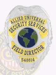 Custom silver eagle top metal badge featuring gold panels for Allied Universal, labeled 'Security Services' and 'Field Director' with a globe emblem in the center and safety pin attachment.