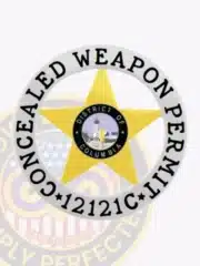 Gold star-shaped concealed carry badge inside a silver circle banner labeled 'Concealed Weapon Permit 12121C', displaying the District of Columbia emblem, designed with a safety pin for easy attachment.