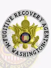 Close-up of a silver circle banner badge with a gold eagle in the center on a 5-point star design, labeled for Washington Fugitive Recovery Agents, including the Alabama Great Seal on the eagle's chest and a safety pin fastener on the back.