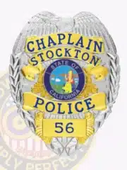 Stockton Police Chaplain badge with a silver eagle on top, gold panels labeled "CHAPLAIN STOCKTON POLICE," a central California state seal, and badge number "56," designed with a safety pin attachment.