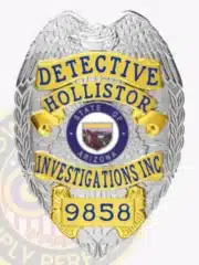 Close-up image of a silver metal badge with gold accent panels for a detective at Hollistor Investigations Inc, featuring an eagle design at the top, blue text including company name and badge number, the Arizona state seal in the center, and a metal safety pin clasp.