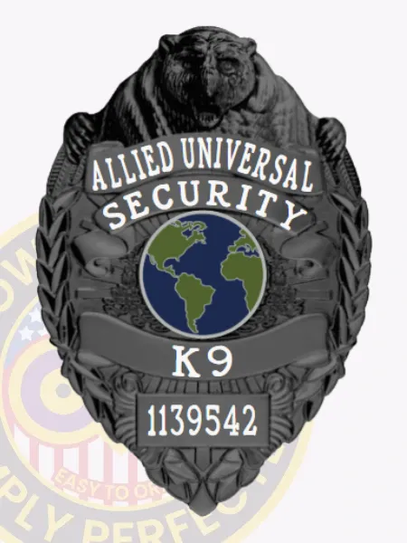 Front view of an Allied Universal custom black metal K9 badge featuring an embossed bear figure at the top, a globe graphic in blue and green center, clear white text stating "Security K9," and a visible safety pin attachment for easy fastening.