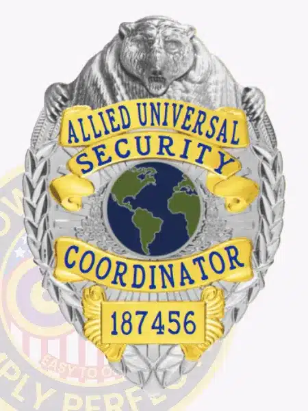 Official custom silver bear top metal badge for Allied Universal Security Coordinator, highlighting gold panels with blue text, a detailed bear figure on top, a globe symbol in the middle, and safety pin attachment.