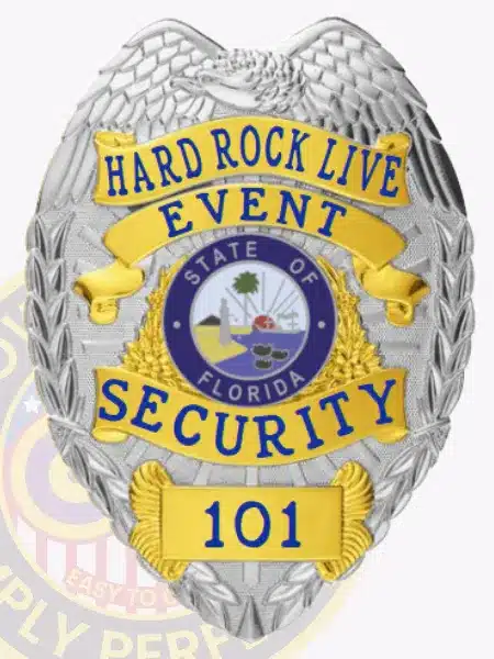 Silver and gold metal badge with eagle design at the top for Hard Rock Live Event Security, displaying bold blue lettering and the official Florida state seal, equipped with a safety pin for attachment.