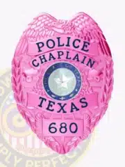 Detailed image of a custom pink BCAM Police Chaplain badge for Texas, featuring a pink eagle at the top, pink banners with black text, the Texas state seal, and badge number "680," designed with a safety pin attachment.