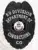 Black custom corrections badge with an eagle motif at the top, labeled "K9 Division Department of Corrections CO," featuring the official Colorado state seal in the center and a safety pin fastener on the back.