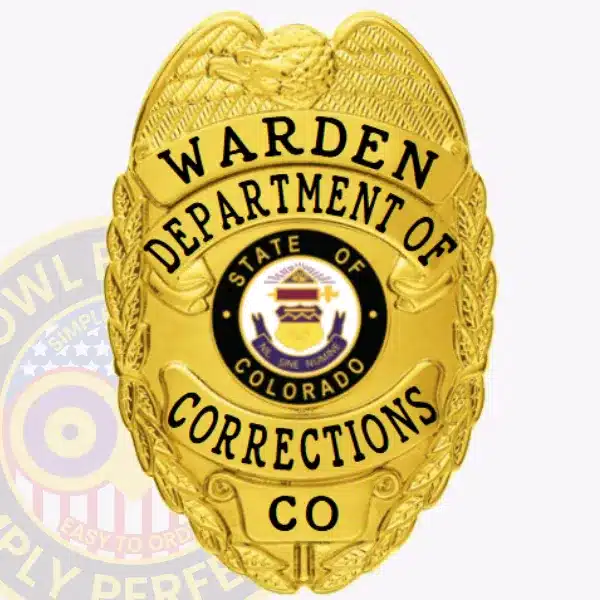 Gold corrections badge designed for the Department of Corrections Warden in Colorado, showcasing a gold eagle crest, black text on gold banners, and the Colorado state seal prominently in the center. Includes a safety pin fastener.