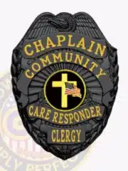Custom black metal badge for Community Care Responder Chaplain, featuring an intricate eagle design at the top, bright yellow lettering around a circular emblem of a cross and waving American flag, and a safety pin attachment for easy fastening.