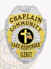 Community Care Responder Chaplain badge in silver with gold accent panels, silver eagle perched at the top, black lettering on gold backgrounds encircling a central yellow cross and American flag emblem, fitted with a safety pin attachment.