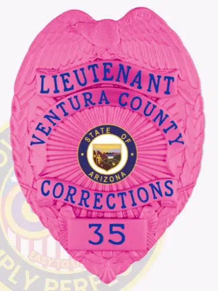 Custom pink metal badge for Ventura County Corrections Lieutenant, featuring an eagle at the top, blue lettering, and safety pin attachment, with badge number 35 and Arizona state emblem in the center.
