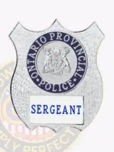 Silver custom shield metal badge for ontario provincial police sergeant, featuring embossed provincial symbols and blue 'sergeant' text on a white patch, secured by a safety pin.