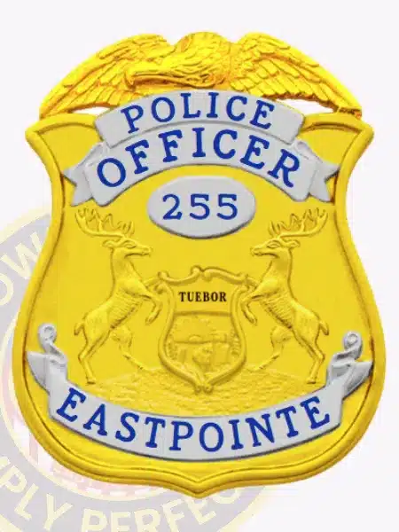 Gold shield-shaped police badge for Eastpointe PD with silver accent panels, eagle top design, central Michigan state emblem reading 'TUEBOR,' and identification number 255, equipped with safety pin.