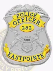 Eastpointe Police Officer badge in silver with gold banners, an eagle perched on top, detailed Michigan state seal in the middle, number 282 displayed, and a safety pin on the back.