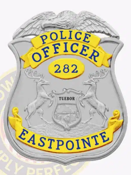 Eastpointe Police Officer badge in silver with gold banners, an eagle perched on top, detailed Michigan state seal in the middle, number 282 displayed, and a safety pin on the back.