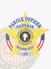 Washington Juvenile Corrections custom badge in gold, shaped as a 5-point star with embossed patterns inside a silver circular banner, featuring the official state seal in blue and gold at the center, blue text around it reading "PAROLE OFFICER JUVENILE CORRECTIONS WASHINGTON," and silver banners indicating "CAPTAIN," "WILSON CITY," plus badge number 25; fitted with a safety pin fastener.
