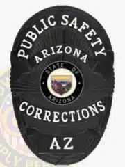 Black oval Public Safety Corrections badge with white text, displaying the Arizona state emblem in the middle, designed for corrections officers in Arizona, secured with a safety pin.
