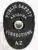 Black oval Public Safety Corrections badge with white text, displaying the Arizona state emblem in the middle, designed for corrections officers in Arizona, secured with a safety pin.