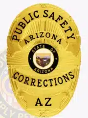 Custom gold oval metal badge for Public Safety Corrections in Arizona, featuring black lettering and the State of Arizona seal at the center, with a safety pin attachment on the back.