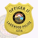 Cop Gold Shield Front. Front view of a shield cop badge in gold for a Lakewood Police officer II.