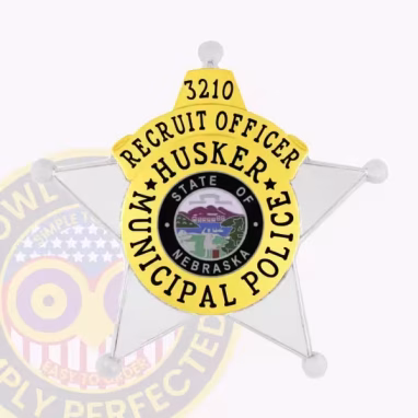 Cop Silver Gold 5 Point Star Front. Front view of a 5 point star cop badge in silver and gold for a Husker Police recruit officer.