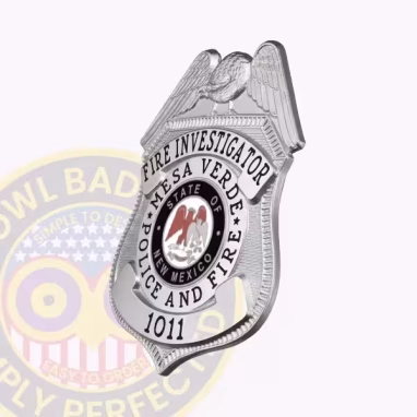 Fire Investigator Eagle Top Badge Side. Side view of a silver eagle top badge for a fire investigator,