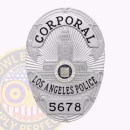Los Angeles Police Badge Front. Front view of an oval shape with a building center Los Angeles Police Badge in silver.