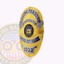 Missing Persons Investigator Oval Badge Side. Side view of a gold and silver missing persons investigator oval badge.
