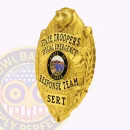 Special Emergency Response Team Bear Top Badge Side. Side view of gold bear top badge for special emergency response team.