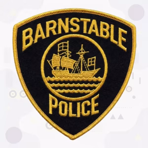 Black circle police patch with a gold sailing ship