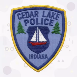 Police shield patch with a sailboat and pine trees