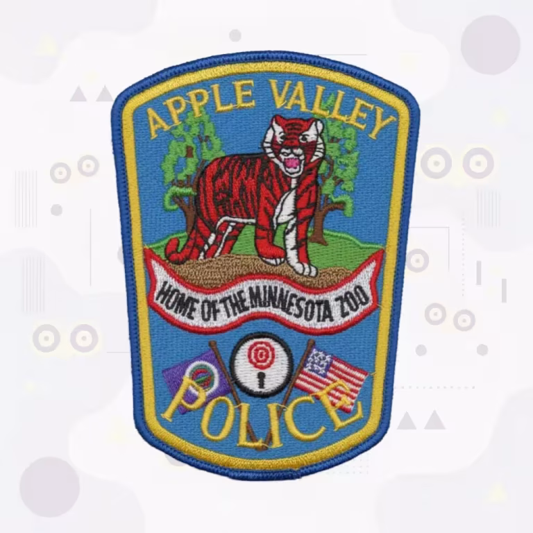 Embroidered police patch with a tiger, crossed flags and motto banner