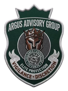 Green shield security patch with a bronze crowned helmet