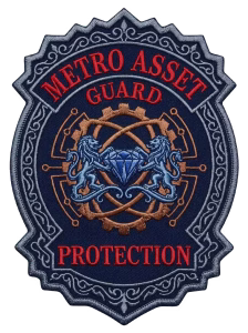 Gray guard patch with red lettering, a gear and twin blue lions