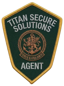 Green shield security patch with a copper griffin and an anchor