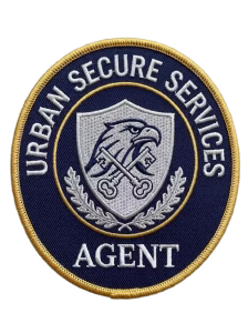 Round navy security patch with an eagle head over crossed keys
